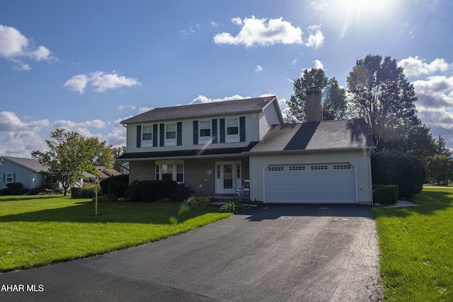 view of property with a garage and a front yard