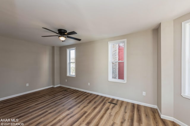 empty room with ceiling fan and wood-type flooring