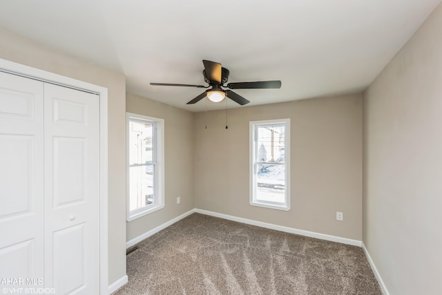 unfurnished bedroom featuring carpet, a closet, and ceiling fan