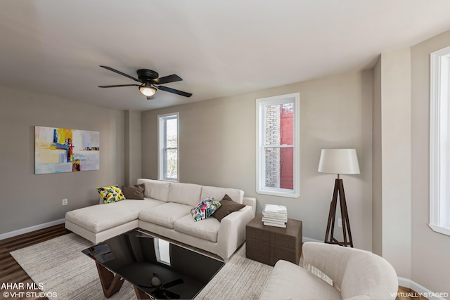 living room featuring hardwood / wood-style floors and ceiling fan