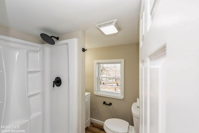 bathroom with wood-type flooring, vanity, toilet, and walk in shower