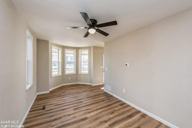 unfurnished room with hardwood / wood-style flooring and ceiling fan