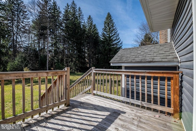 wooden terrace featuring a lawn