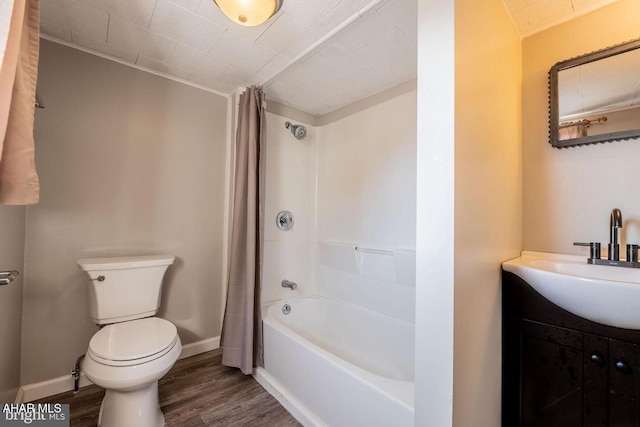 full bath featuring baseboards, toilet, wood finished floors, and vanity