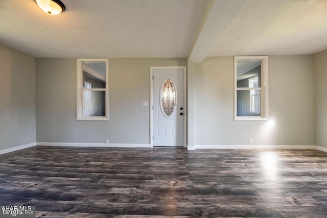 entryway featuring dark wood-style floors and baseboards