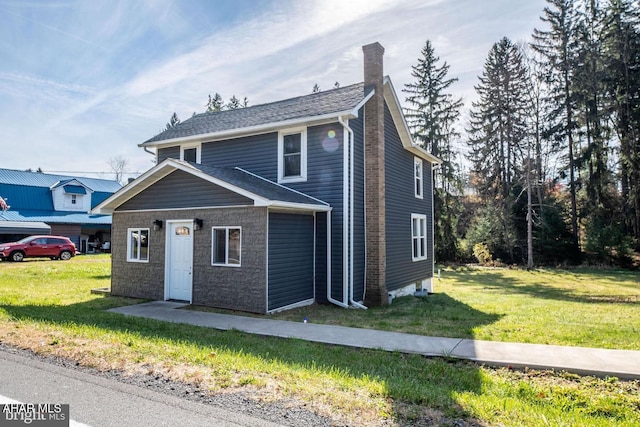 view of front of house with a front yard and a chimney