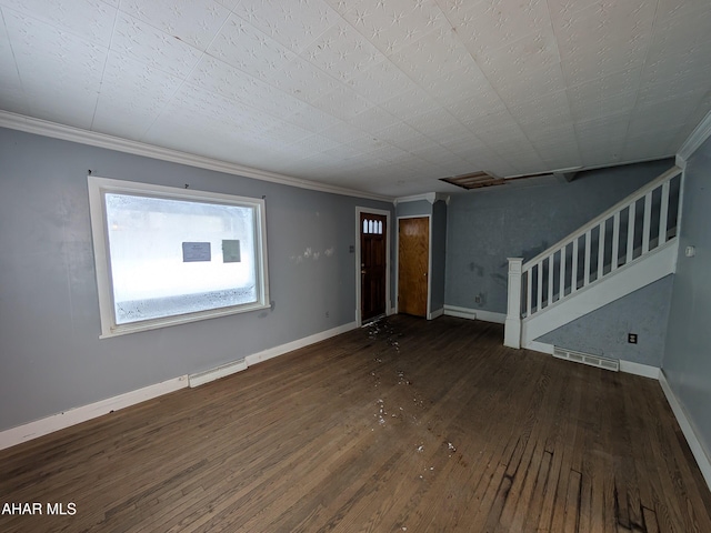 spare room featuring ornamental molding and dark hardwood / wood-style floors