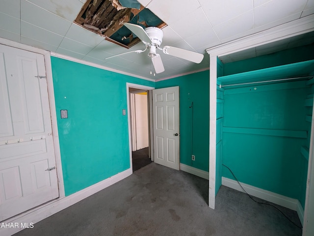 unfurnished bedroom with ceiling fan, ornamental molding, carpet floors, and a closet