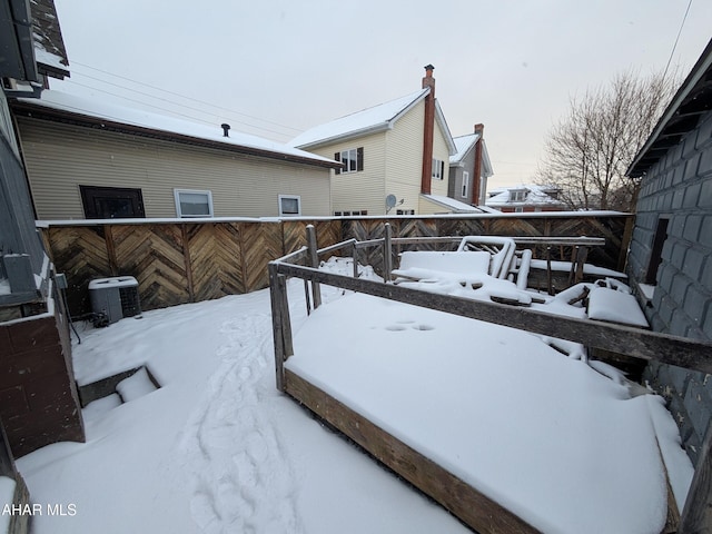 yard covered in snow with central AC