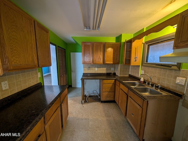 kitchen featuring tasteful backsplash, a healthy amount of sunlight, and sink