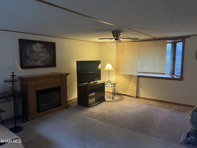 carpeted living room featuring a textured ceiling and ceiling fan