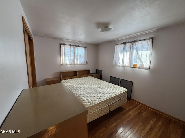 unfurnished bedroom featuring dark hardwood / wood-style flooring and a closet