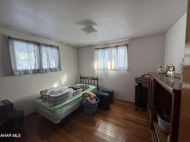 bedroom with dark wood-type flooring