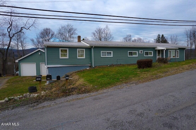 single story home with a front yard and a garage