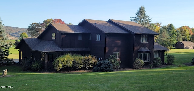 view of side of home with a yard