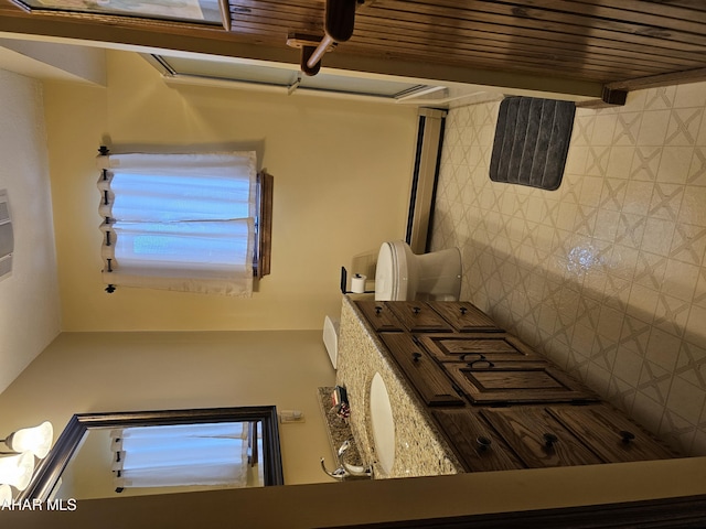 bathroom with tasteful backsplash and toilet