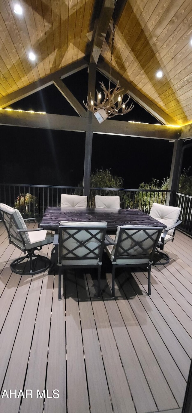 deck at night featuring an outdoor living space