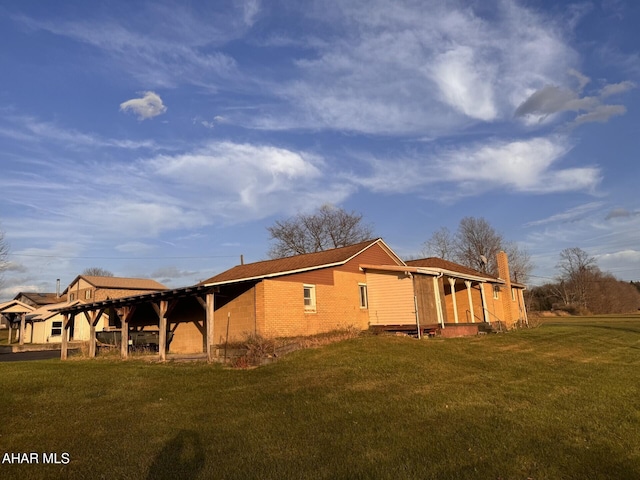 view of side of home featuring a yard