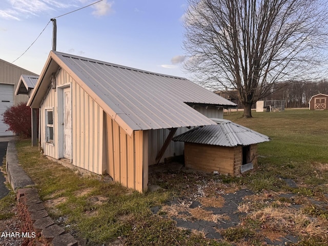 view of side of property featuring a yard and an outdoor structure