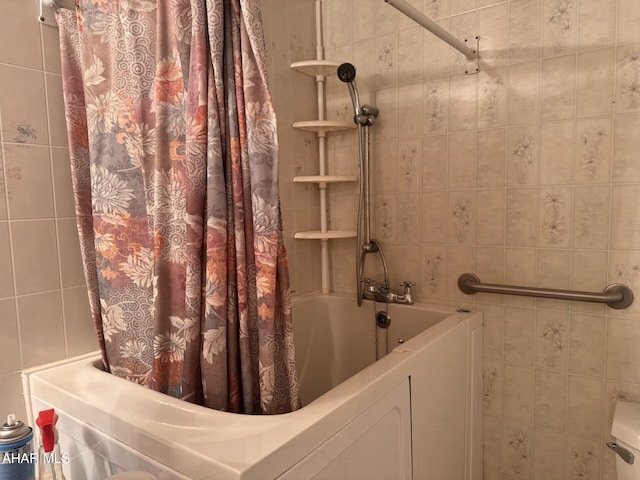 bathroom featuring shower / bath combination with curtain and tile walls