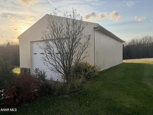 outdoor structure at dusk with a yard and a garage