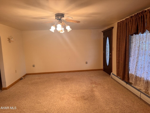 carpeted empty room featuring ceiling fan and a baseboard radiator