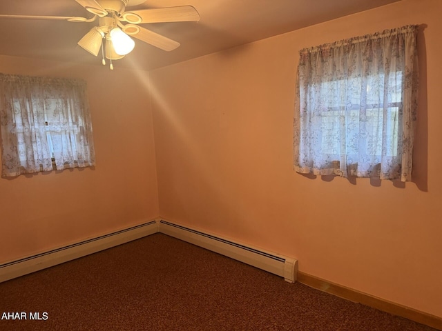 empty room with carpet, ceiling fan, and a baseboard radiator