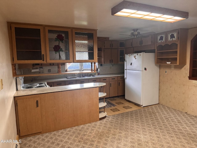 kitchen with ceiling fan, white appliances, sink, and light carpet