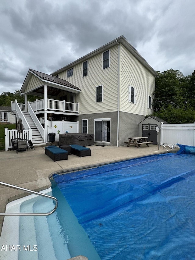 153 Frederick Rd, Altoona, PA 16602 - back of house featuring stairs, a storage shed, a patio area, and an outbuilding