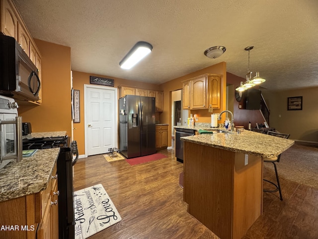 153 Frederick Rd, Altoona, PA 16602 - kitchen with black appliances, a sink, a peninsula, a textured ceiling, and dark wood-type flooring