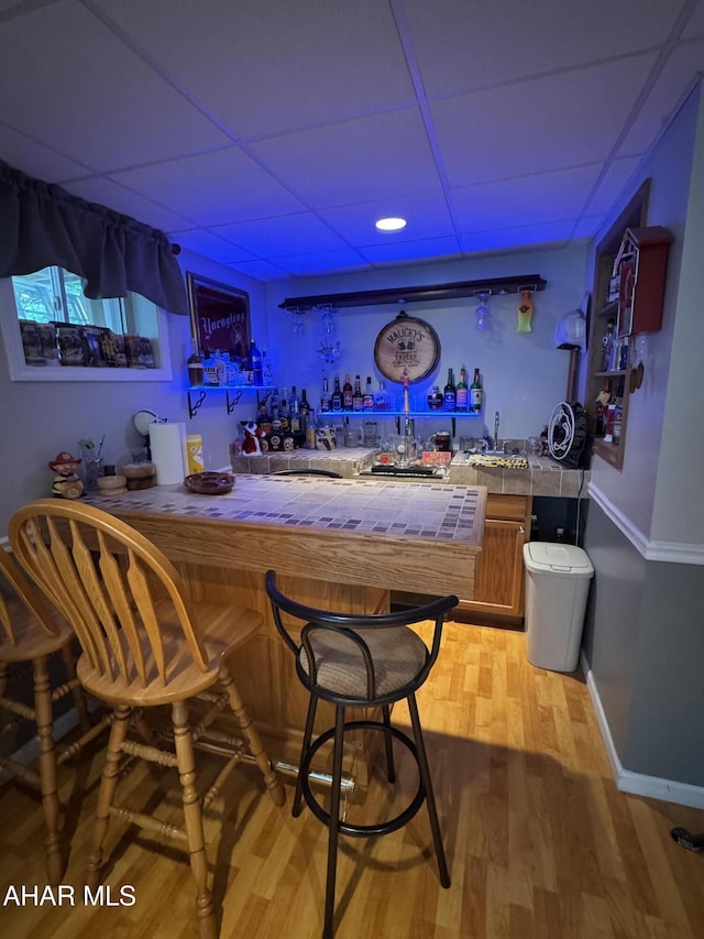 153 Frederick Rd, Altoona, PA 16602 - indoor wet bar with a drop ceiling, light wood-style flooring, and baseboards