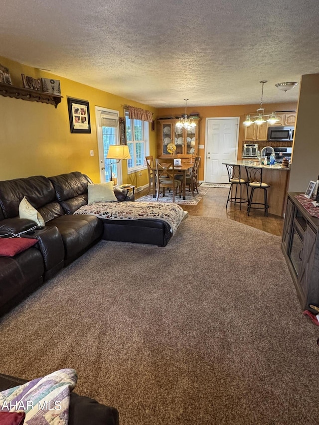 153 Frederick Rd, Altoona, PA 16602 - carpeted living area featuring a chandelier and a textured ceiling