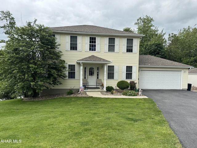 153 Frederick Rd, Altoona, PA 16602 - colonial inspired home with asphalt driveway, an attached garage, a front yard, and roof with shingles