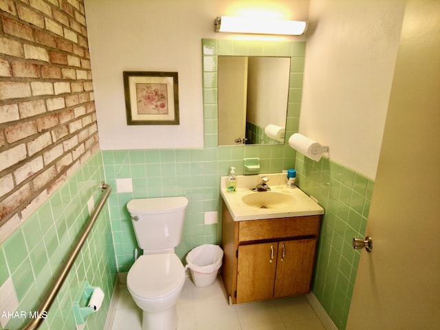 bathroom with tile patterned floors, vanity, toilet, and tile walls