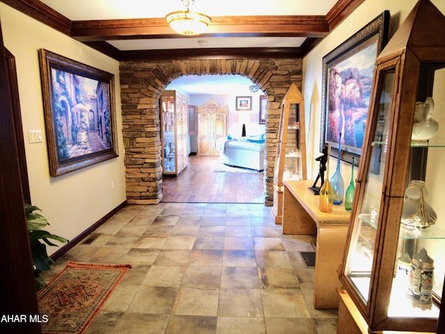 corridor with beamed ceiling, plenty of natural light, ornamental molding, and light hardwood / wood-style flooring