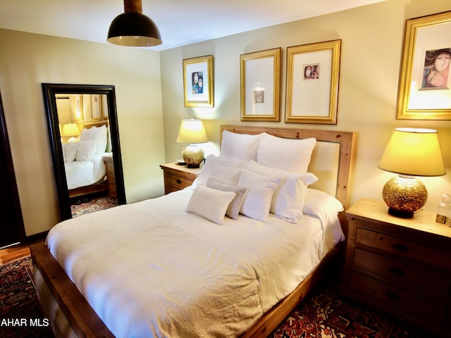 bedroom featuring dark hardwood / wood-style flooring