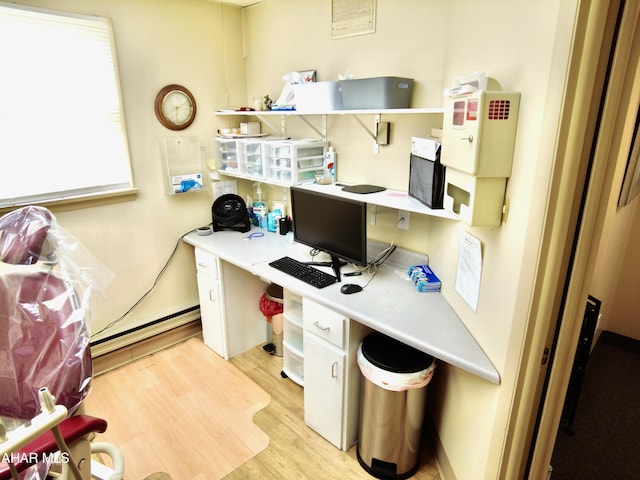 office with baseboard heating and light hardwood / wood-style flooring