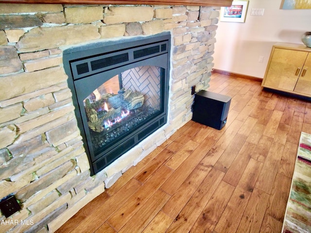 room details featuring a fireplace and hardwood / wood-style flooring