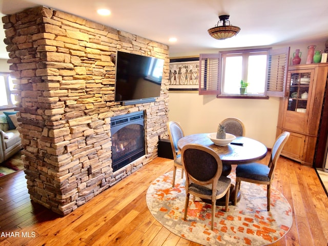 dining space with a fireplace and light wood-type flooring