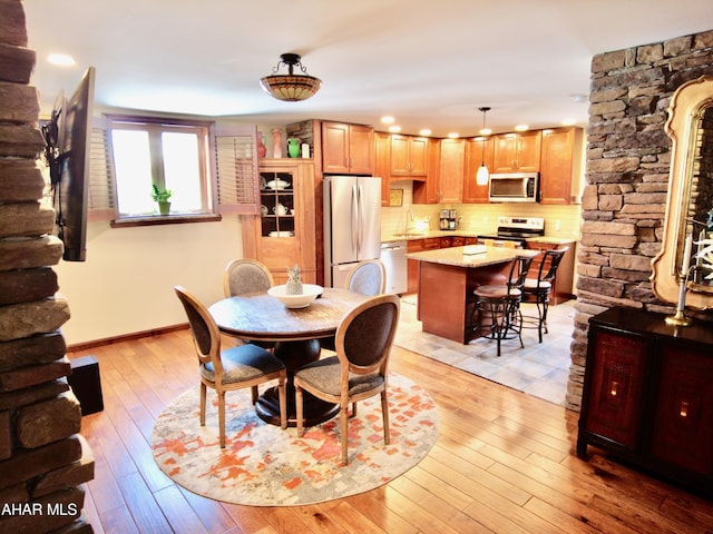 dining room with sink and light hardwood / wood-style flooring