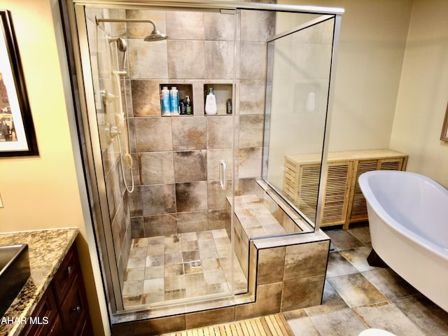 bathroom featuring shower with separate bathtub and vanity