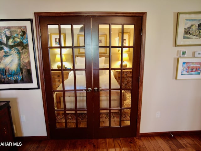 interior details with french doors and wood-type flooring