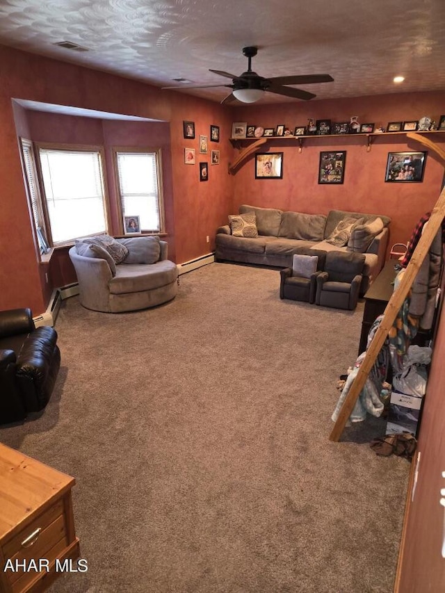 carpeted living room featuring a textured ceiling, baseboard heating, and ceiling fan