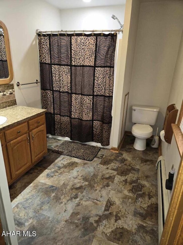 bathroom with vanity, curtained shower, toilet, and baseboard heating