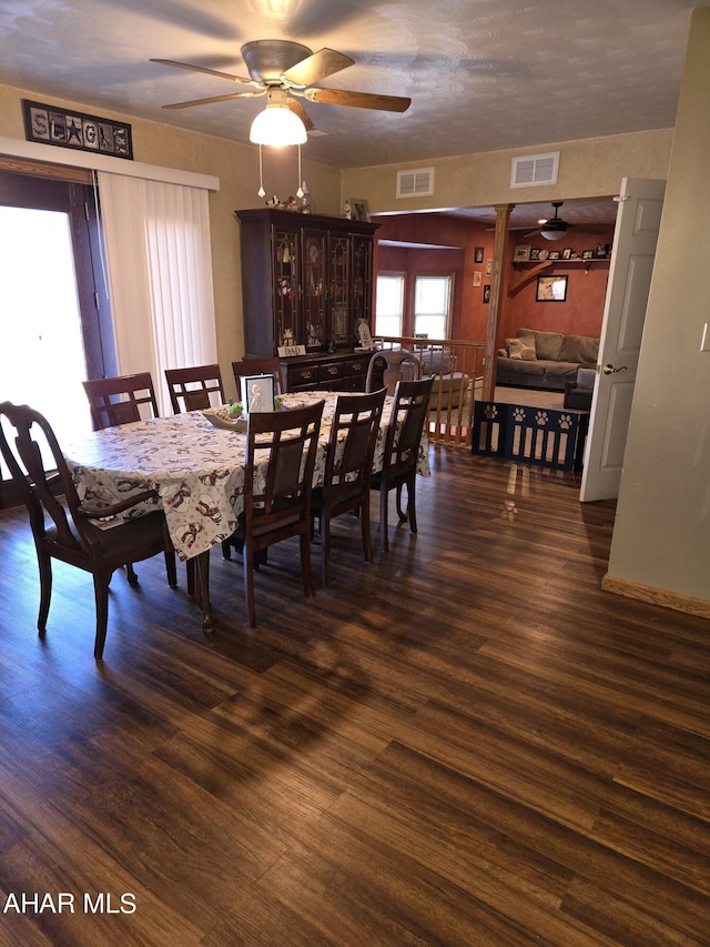 dining space with dark hardwood / wood-style flooring and ceiling fan