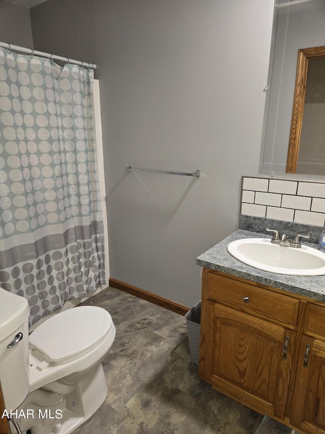 bathroom featuring vanity, toilet, and curtained shower