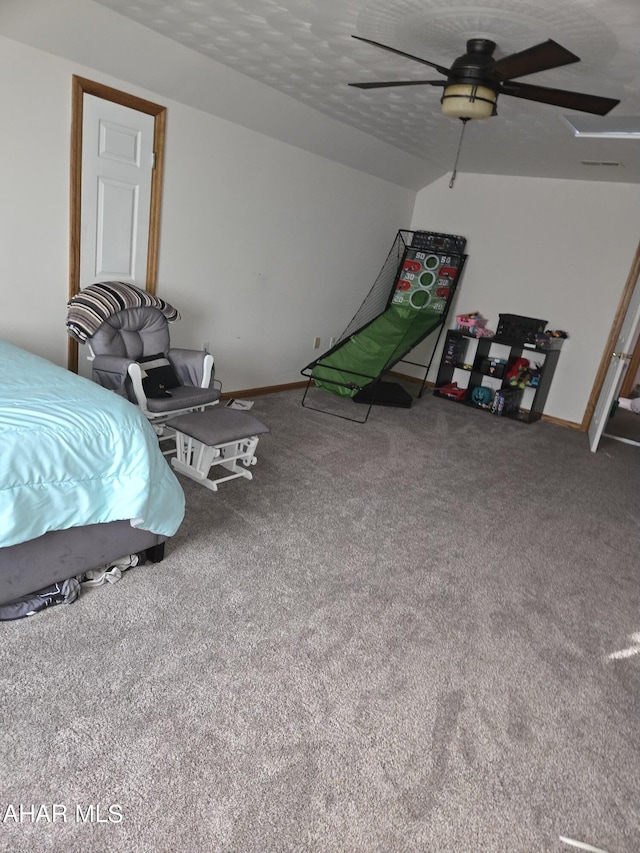 carpeted bedroom with ceiling fan and a textured ceiling