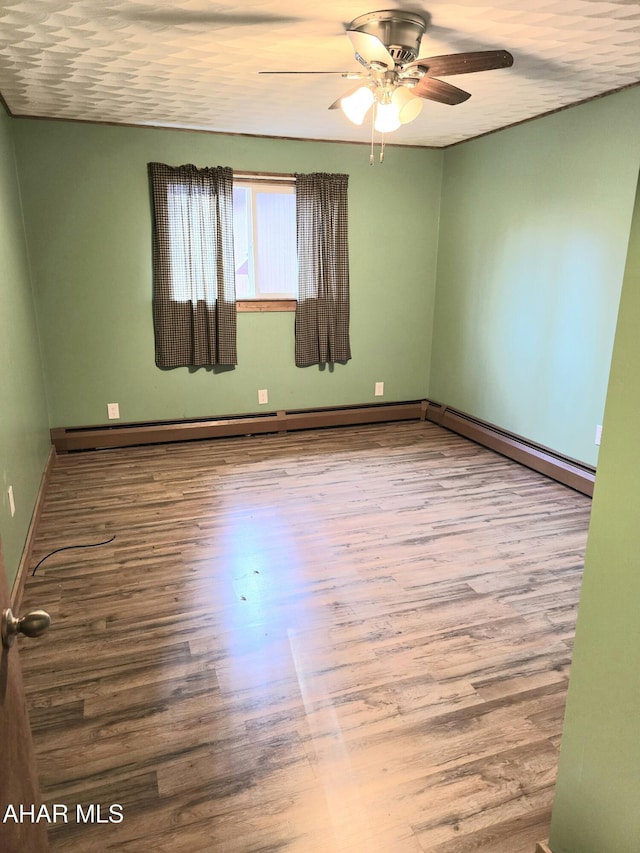 unfurnished room featuring hardwood / wood-style floors and ceiling fan