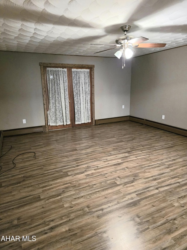 unfurnished room with ceiling fan and hardwood / wood-style flooring