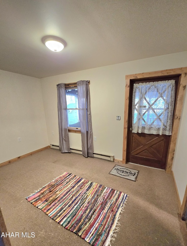 entrance foyer with carpet flooring and baseboard heating